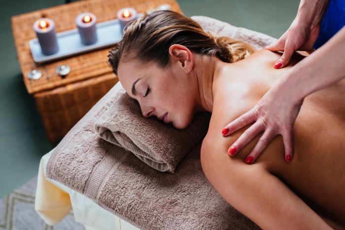 Beautiful woman getting thai massage in exotic spa
